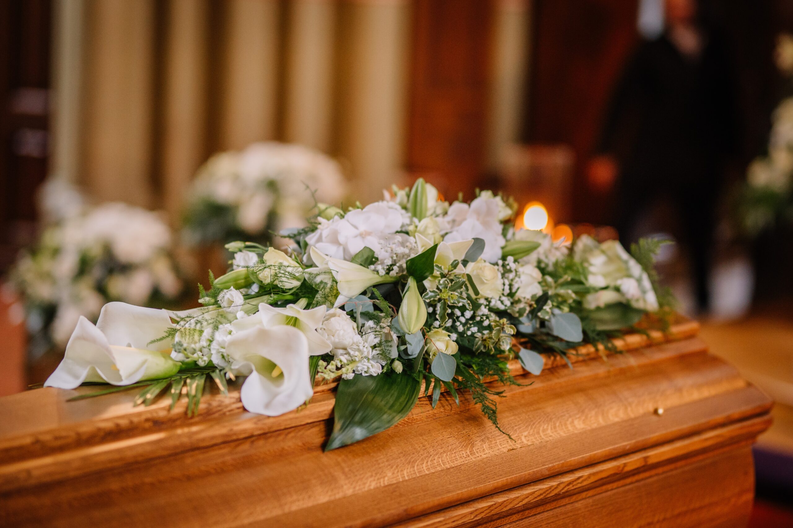 A funeral director assisting a family in planning funeral services, discussing burial and cremation options in a comforting setting.